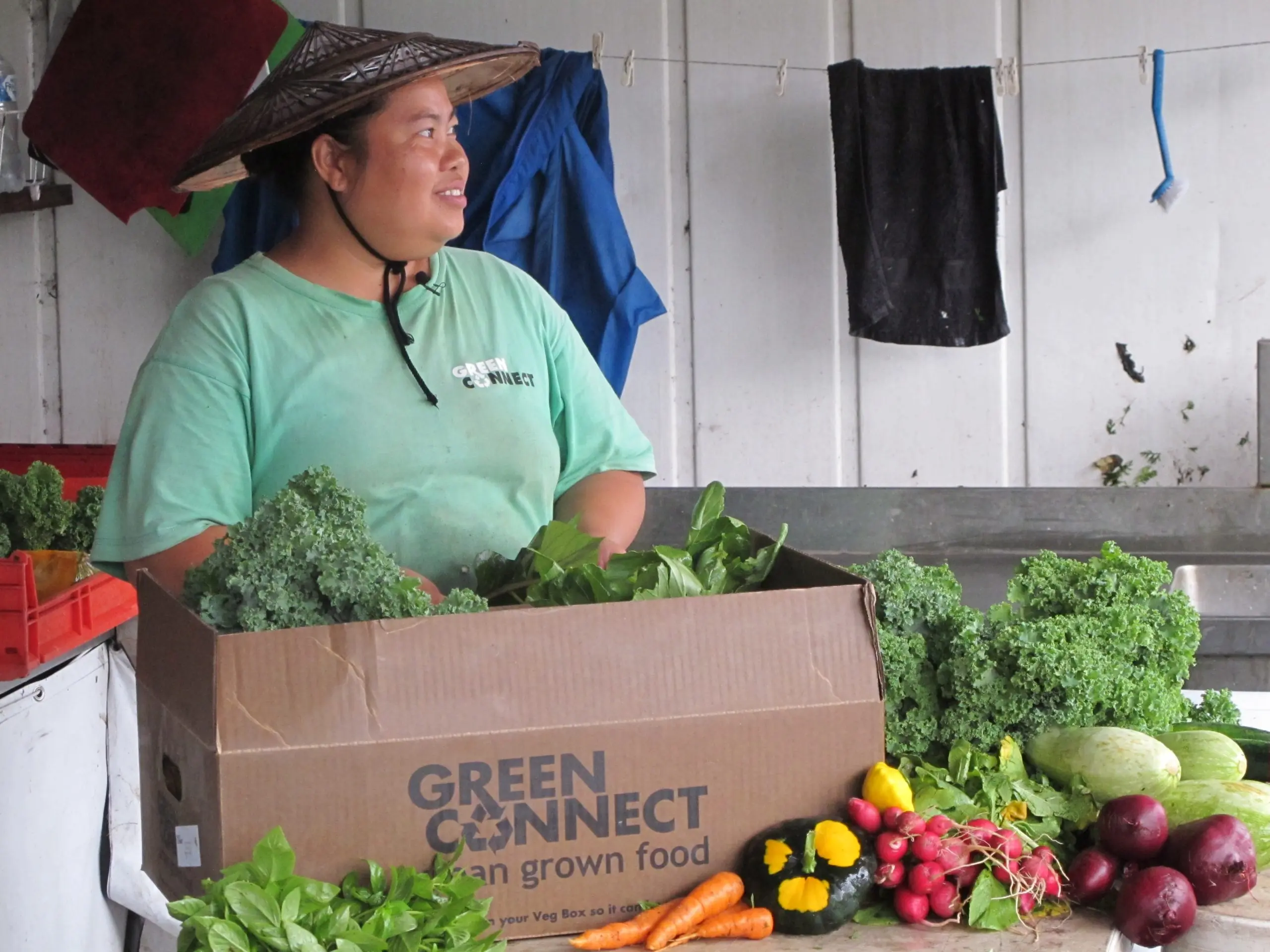 Former Refugee Sue Meh with Green Connect veg boxes