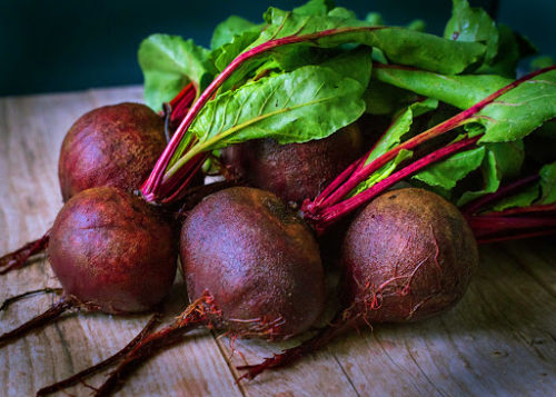 Beetroots with leaves on table