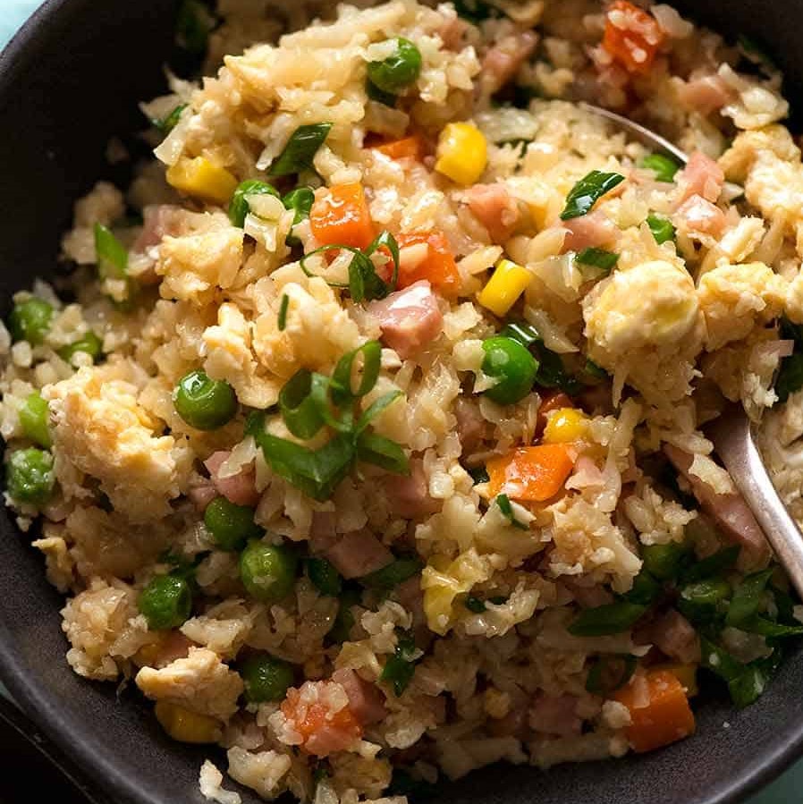 close-up of cauliflower friend rice with carrots, peas, corn, ham and spring onion