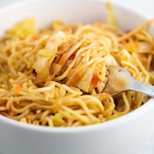 Cabbage stirfry noodles in white bowl