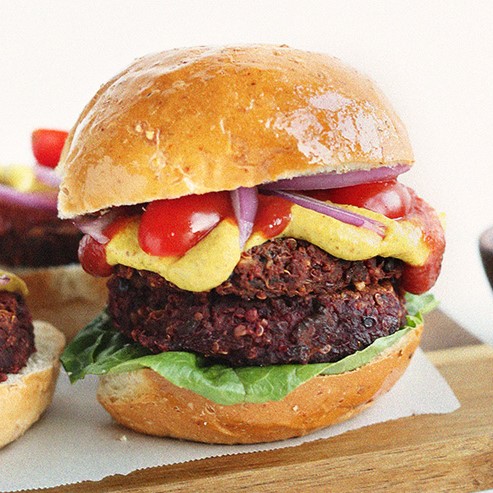 Burger with 2 quinoa black bean beetroot patties, cheese and tomatoes