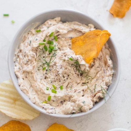 White bowl with creamy coloured dip, topped with fennel fronds